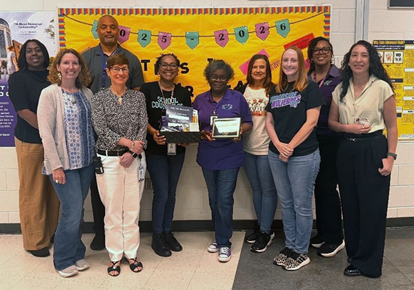 Woodside faculty posing with award