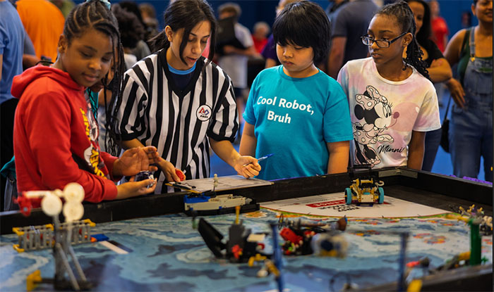 Four children participating in a robot challenge