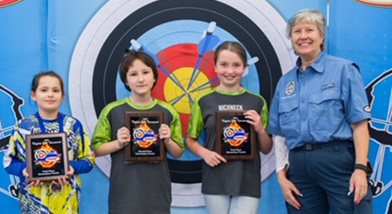 Hadassah Bates, Donnell Lomax and Addisyn Williamson earned top scores in team competition and smile here with Karen Holson, Virginia's NASP supervisor.